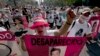 FILE - Mothers, relatives and friends march with banners and posters showing images of relatives that have been disappeared, during Mother's Day, in Mexico City.