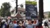 File Photo: A protester is holding a sign that reads 'Free the Activists'