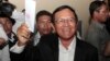 Opposition Cambodia National Rescue Party President Kem Sokha shows off his ballot before voting in local elections in Chak Angre Leu on the outskirts of Phnom Penh, Cambodia, Sunday, June 4, 2017. (AP Photo/Heng Sinith)