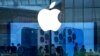 FILE - People check out the latest iPhone 13 handsets at an Apple Store in Beijing, China, Sept. 28, 2021. Amazon’s audiobook service Audible and phone apps for reading the Quran and Bible have become inaccessible for users in mainland China.