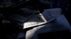 A woman arranges Chinese newspapers, as one of them with the headlines of President Donald Trump tested positive for the coronavirus, at her newsstand in Beijing, Saturday, Oct. 3, 2020. President Trump said Friday that he and first lady Melania…