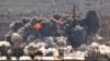 FILE - Smoke and flames rise from an Islamic State fighters' position in the town of Kobani during airstrikes by the U.S.-led coalition seen from the outskirts of Suruc, near the Turkey-Syria border, Oct. 28, 2014. 