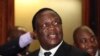 FILE - Zimbabwean Deputy President Emmerson Mnangagwa smiles at the headquarters of ZANU (PF) in Harare, Dec.10, 2014. 