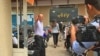 Moeun Tola, executive director of the Center for Alliance of Labor and Human Rights (CENTRAL), waved to reporters as he enters the Phnom Penh Municipal Court, Cambodia, May 25, 2018. (Hul Reaksmey/VOA Khmer)