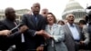 From left, House Assistant Minority Leader James Clyburn, Rep. John Lewis, D-Ga., Rep. Joseph Crowley, D-N.Y., House Minority Leader Nancy Pelosi of California, and Rep. Charles Rangel, D-N.Y., sing "We Shall Overcome" on Capitol Hill, in Washington, June
