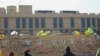 FILE - Portraits of fighters from Kataeb Hezbollah are seen on the wall of the U.S. embassy in the Iraqi capital Baghdad, Jan. 1, 2020, after they were placed by protesters. The militia brushed off U.S. sanctions on the group ver attacks against U.S. forces in Iraq and Syria.
