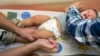 Pediatrician Charles Goodman vaccinates Cameron Fierro, 1, with the measles-mumps-rubella vaccine at his practice in Northridge, California, Jan. 29, 2015. 