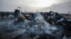 Palestinians look at the destruction after an Israeli strike where displaced people were staying in Rafah, Gaza Strip, May 27, 2024. 
