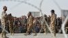 FILE - People wait to cross into Afghanistan at the Pakistani border post Chaman, Sept. 1, 2016.
