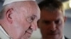 Pope Francis talks with his spokesperson Matteo Bruni, as he addresses journalists during his flight from Antamanarivo to Rome, Sept. 10, 2019, after his seven-day pastoral trip to Mozambique, Madagascar, and Mauritius. 
