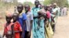 File - Residents displaced due to the fighting between government and rebel forces in the Upper Nile capital Malakal wait at a World Food Program outpost.