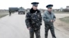 Ukrainian officers return after negotiations with Russian troops (L) at the Belbek airport in the Crimea region, March 4, 2014. 