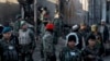 FILE - Afghan security forces inspect damages after clashes between Taliban fighters and Afghan forces in Kandahar, Afghanistan, Dec. 9, 2015. An overnight Taliban attack in Kandahar province killed 11 government soldiers, an Afghan Defense Ministry statement said Tuesday.