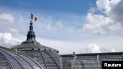 A French flag flying at half-mast at the Grand Palais in Paris, July 28, 2014.