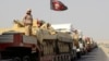 FILE - A convoy of Iraqi security forces advances on the outskirts of Mosul, Oct. 12, 2016. The battle for Mosul is weeks or perhaps days away. 