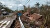 Houses destroyed by Typhoon Goni lie along the side of road in Albay province, central Philippines, on Nov. 3, 2020.