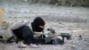 FILE - A U.S. Navy SEAL member provides cover for his teammates advancing on a suspected location of al-Qaida and Taliban forces, Jan. 26, 2002.