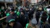 FILE - Cleveland police walk with pedestrians as they patrol downtown, March 17, 2016. City officials have been coy about plans for handling convention protests, saying only they are prepared for “challenges.”