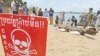 FILE PHOTO - Journalists take photographs of a bomb pulled from the murky depths of the Mekong River, Phnom Penh, Cambodia. 