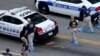 An FBI evidence response team works the crime scene, July 10, 2016, where five Dallas police officers were killed Thursday, in Dallas.