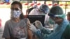A health worker administers a dose of the AstraZeneca COVID-19 vaccine to a resident of the Klong Toey area, a neighborhood currently having a spike in coronavirus cases, in Bangkok, Thailand, Monday, May 10, 2021. (AP Photo/Vichan Poti) 