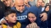 Al Jazeera journalist Wael Al-Dahdouh hugs his daughter and son as they attend the funeral of his son, Palestinian journalist Hamza Al-Dahdouh, after Hamza was killed in an Israeli strike, in Rafah in the southern Gaza Strip, Jan. 7, 2024. 