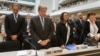Delegate stands for a minute of silence in memory of the deceased health workers at the World Health Organization (WHO) assembly, May 18, 2015, Geneva. 