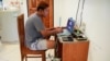 Journalist Min Het Mone, whose parents cut ties with him, works in his room, at Thai-Myanmar border, Jan. 26, 2022. 