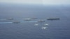 4月28日在沖繩附近海域，日本兩艘軍艦和兩架F15戰機參加美國核航母“卡爾·文森”號為首的美軍戰艦群和航母搭載機聯合軍演時的布陣航行、飛行環節（日本航空自衛隊提供）