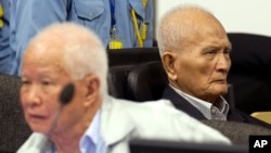 In this photo released by the Extraordinary Chambers in the Courts of Cambodia, Khieu Samphan, left, former Khmer Rouge head of state, and Nuon Chea, right, who was the Khmer Rouge's chief ideologist and No. 2 leader, sit in the court hall before they made closing statements at the U.N.-backed war crimes tribunal in Phnom Penh, file photo. 