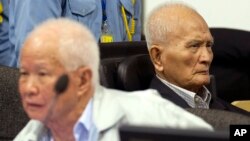 In this photo released by the Extraordinary Chambers in the Courts of Cambodia, Khieu Samphan, left, former Khmer Rouge head of state, and Nuon Chea, right, who was the Khmer Rouge's chief ideologist and No. 2 leader, sit in the court hall before they made closing statements at the U.N.-backed war crimes tribunal in Phnom Penh, file photo.