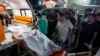 Palestinian medics move people killed in the Israeli bombardment of Al Zawayda in the central of Gaza Strip to the morgue of Al Aqsa hospital in Deir al Balah, Gaza Strip, early May 22, 2024. 