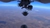 An image grab made from a video released Oct. 5, 2015, by the Russian Defense Ministry reportedly shows a Russian aircraft dropping bombs during an airstrike against Islamic State group's positions at an undisclosed location in Syria. 