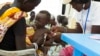 FILE - In this photo of Friday, July 25, 2014, a child with suspected malnutrition is examined at IMC nutrition program clinic in Malakal, South Sudan. 
