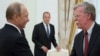 Russian President Vladimir Putin, left, and U.S. National security adviser John Bolton greet each other as Russian Foreign Minister Sergey Lavrov, center, looks on during the meeting in the Kremlin in Moscow, Russia, June 27, 2018. 