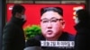 People walk by a TV screen showing North Korean leader Kim Jong Un during a ruling party congress, at the Seoul Railway Station in Seoul, South Korea, Wednesday, Jan. 6, 2021. Kim opened his country's first ruling party congress in five years with…