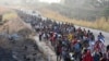 FILE - Migrants walk along the highway through Arriaga, Chiapas state in southern Mexico, Jan. 8, 2024, during their journey north toward the U.S. border.