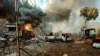 FILE - In this photo provided by the Karenni Nationalities Defense Force, smoke and flames billow from vehicles in Hpruso township, Kayah state, Myanmar, Dec. 24, 2021.