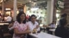 Sonal Jain (right in white shirt) takes a break from office to relax over a cup of tea with a friend. (A. Pasricha/VOA)