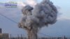 This image taken from video provided by the Syrian activist-based media group Syrian Revolutionary Command Council in Hama, which has-been verified and is consistent with other AP reporting, shows smoke rising after a Russian airstrike hit buildings in th