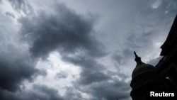 FILE PHOTO: Storm clouds pass over the U.S. Capitol in Washington