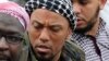 This photo taken on May 5, 2012, shows former German rapper Denis Cuspert, center, among salafi in Bonn, Germany.