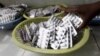 FILE - Ruth Munyao, a pharmacist, dispenses antiretroviral (ARV) drugs at the Mater Hospital in Kenya's capital Nairobi, Sept. 10, 2015. 