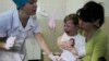 FILE - A boy reacts after receiving a vaccine from a nurse at Children's Hospital No. 1 in Kyiv, Ukraine.
