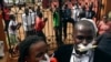 Employees of the Daily Monitor newspaper with their mouths taped shut, sing slogans during a protest against the closure of their premises by the Uganda government, outside their offices in the capital Kampala, Uganda, May 20, 2013.