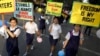 FILE - School girls hold placards as part of an awareness campaign against human trafficking in Kolkata, India, Feb. 15, 2015.