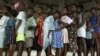 FILE - Liberian children queue for their measles vaccinations in an International Rescue Committee clinic in Monrovia, August 26, 2003.