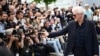 US actor Richard Gere filming with his mobile phone the photographers during a photocall for the film "Oh Canada" at the 77th edition of the Cannes Film Festival in Cannes, southern France, on May 18, 2024. (Photo by LOIC VENANCE / AFP)