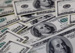 FILE PHOTO: U.S. one hundred dollar notes are seen in this picture illustration taken in Seoul, Feb. 7, 2011.