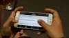 A user explores “Cambodian Voter’s Voice”, a new mobile app developed by Cambodia's election watchdog COMFREL, on August 27, 2015. (Hean Socheata/VOA Khmer) 